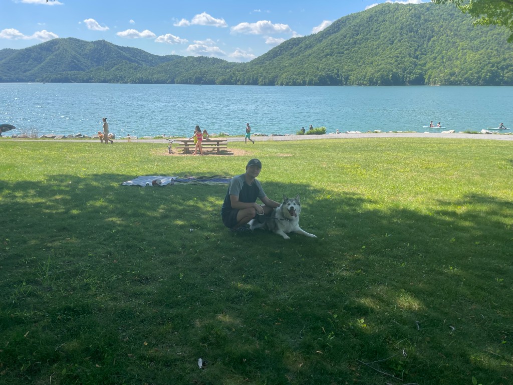 Visitors and dog by the Watauga Lake shoreline